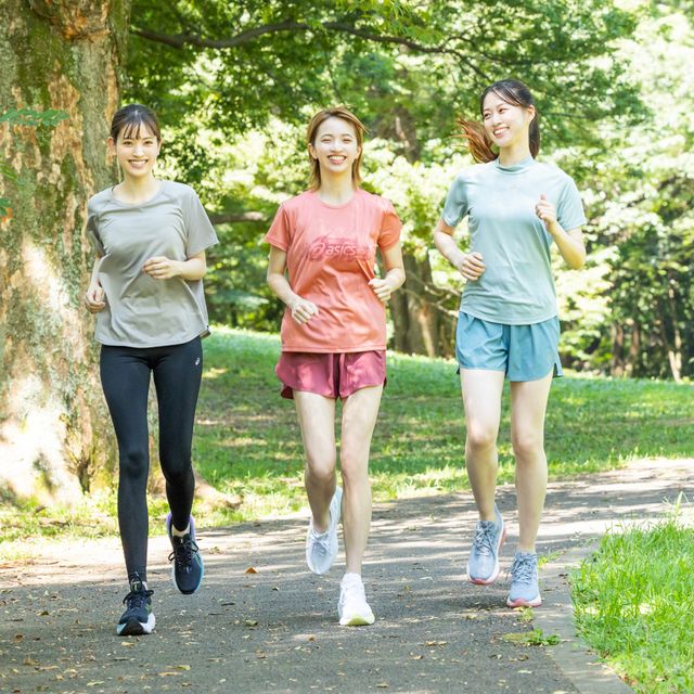 a group of women running on a path