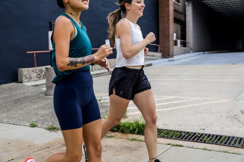 a pair of runners in high waisted bike shorts and loose running shorts