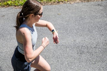a person running on a path while checking a smartwatch