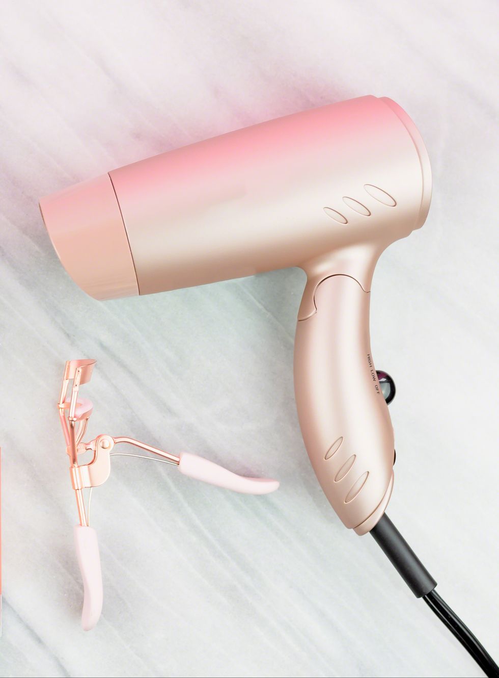 Women’s styling tools and cosmetics in rose gold