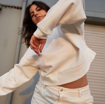 woman dancing in white sweatshirt