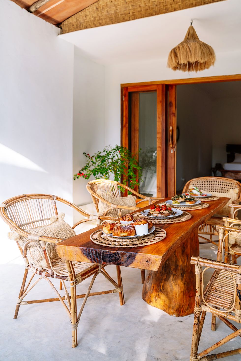wooden dining with brunch breakfast at hotel room and tropical decoration