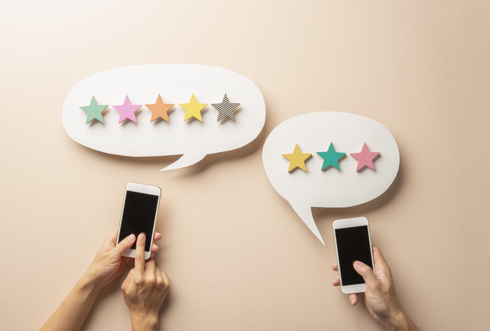 wooden five star shape with chat bubble and smart phone