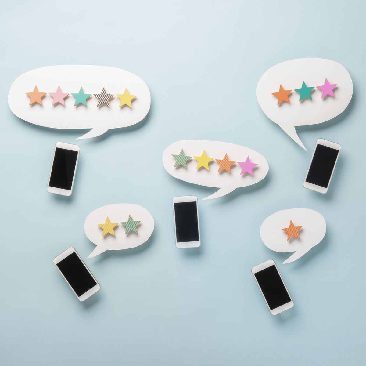 wooden five star shape with chat bubble and smart phone