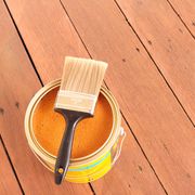 wooden floorboards with oil and paintbrush