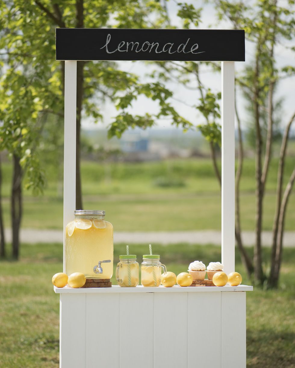 wooden kiosk with lemonade and lemons, children's decorations in the park