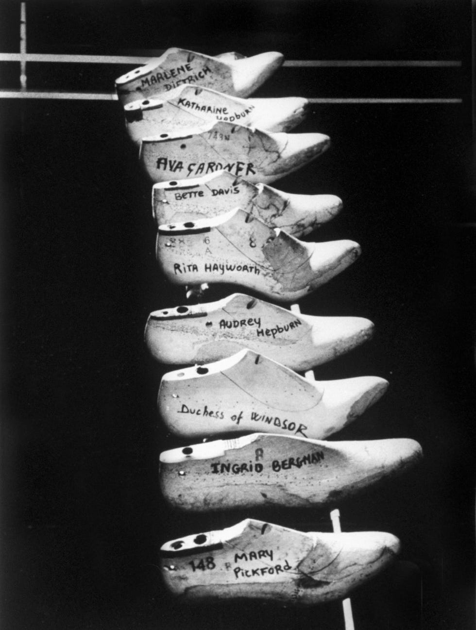 wooden shoe forms of famous women at shoemaker ferragamo mary pickford, ava gardner, marlene dietrich, duchess of windsor, katharine hepburn, rita hayworth, bette davis, audrey hepburn and ingrid bergman