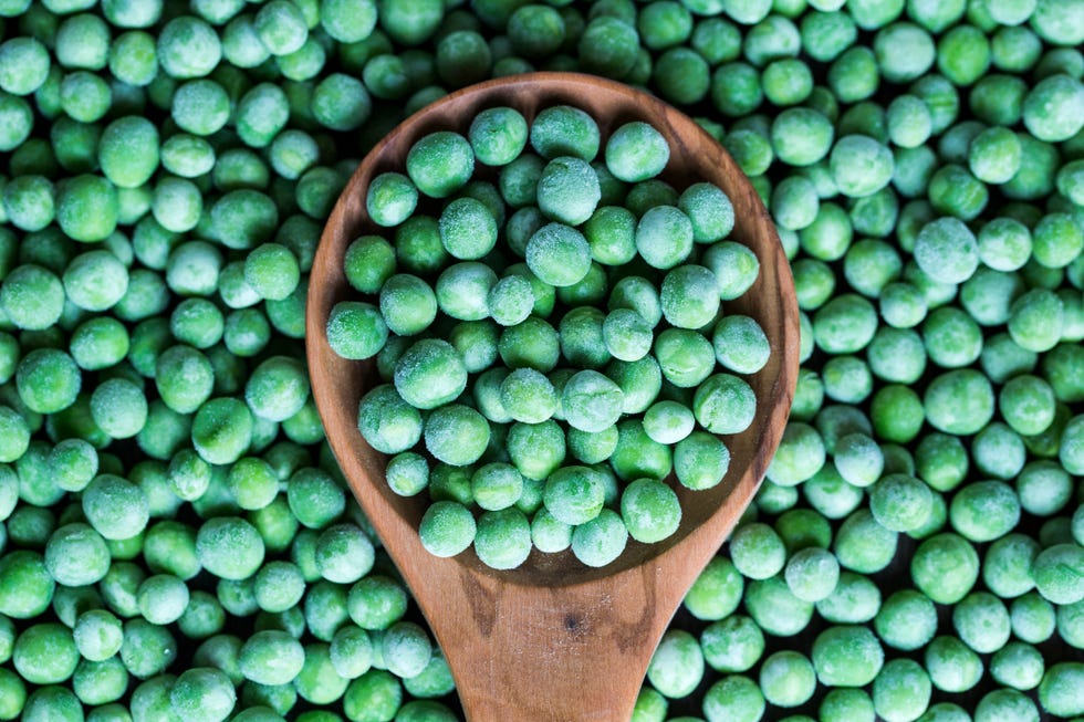 https://hips.hearstapps.com/hmg-prod/images/wooden-spoon-and-frozen-peas-royalty-free-image-1584104929.jpg?crop=0.668xw:1.00xh;0.173xw,0&resize=980:*