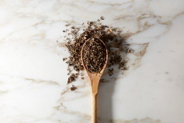 wooden spoon with valerian root on marble