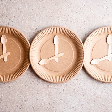 Wooden spoons on a biodegradable birch wood disposable plate, top view. 16:8 intermittent fasting concept. wooden spoons on a biodegradable birch wood disposable plate, top view 168 intermittent fasting concept
