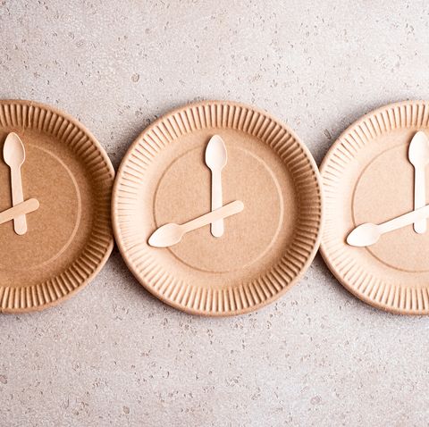 wooden spoons on a biodegradable birch wood disposable plate, top view 168 intermittent fasting concept