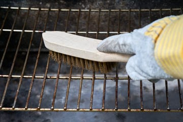 using a wooden wire brush to clean a dirty grill