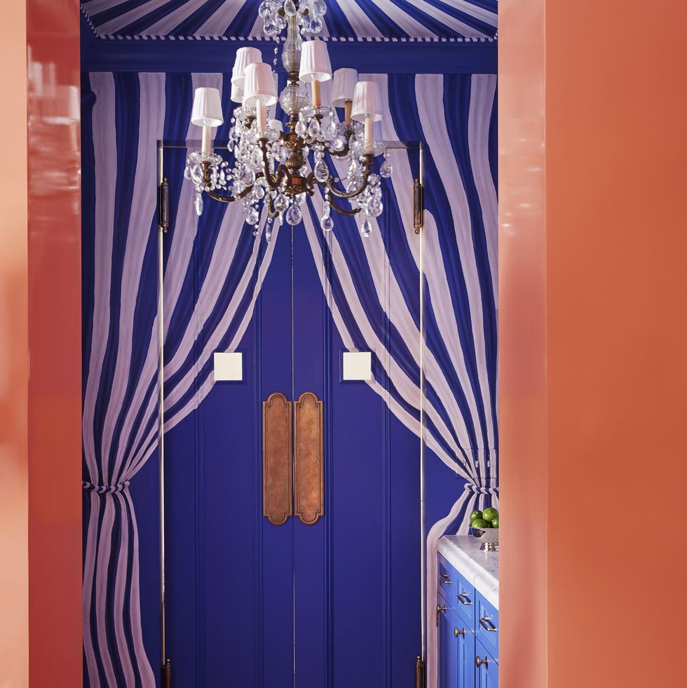 blue and white cabana striped tenting drapes the bar and its slim swinging doors