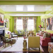 vivid dragon print draperies jim thompson and glossy apple green walls cloak the living room in a carousal of color