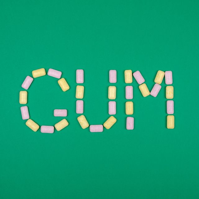 word gum written with chewing gum on green background