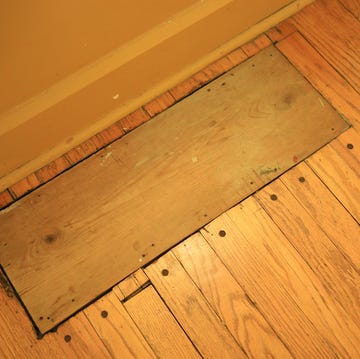 words board covering a hole in the hardwood floor