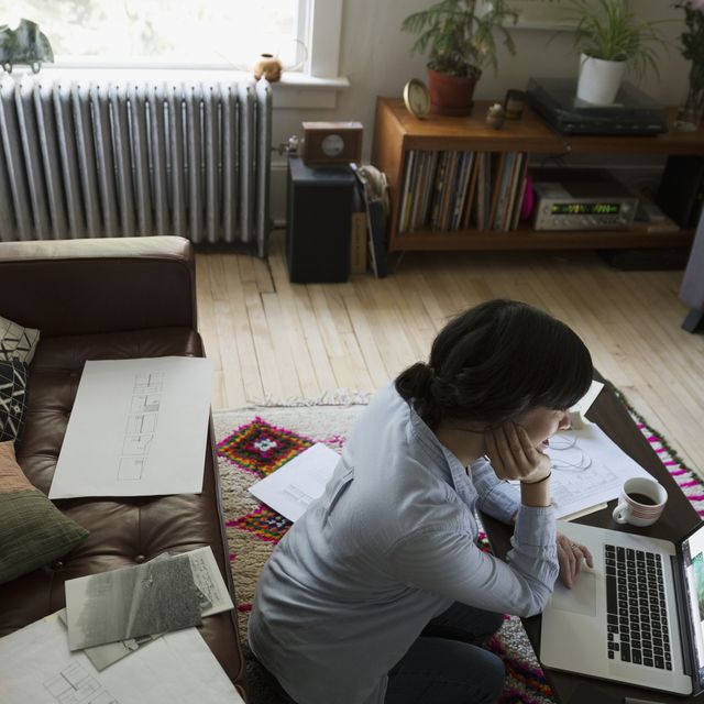 Positive japanese woman freelancer working from home, using