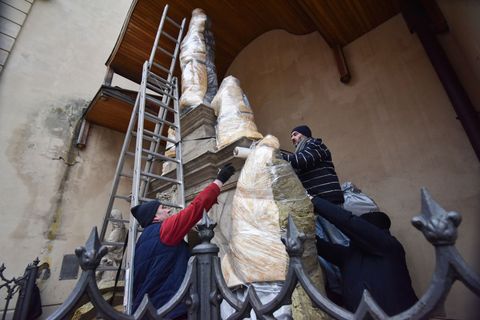 workers wrap sculptures near latin cathedral in lviv to anticipate possible russian shelling