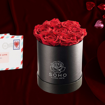 a collection of romantic gifts including a letter keeping book a bouquet of red roses chocolate hearts and heartshaped boxes a collection of romantic gifts including a letter keeping book a bouquet of red roses chocolate hearts and heartshaped boxes
