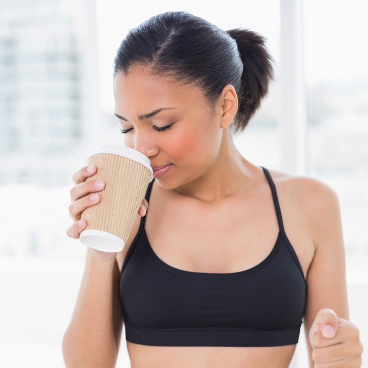woman sniffing coffee