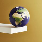 climate change conference a world globe balanced on the edge of a shelf