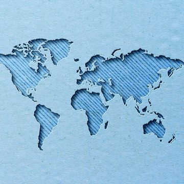 world map with paper cut effect on blue background