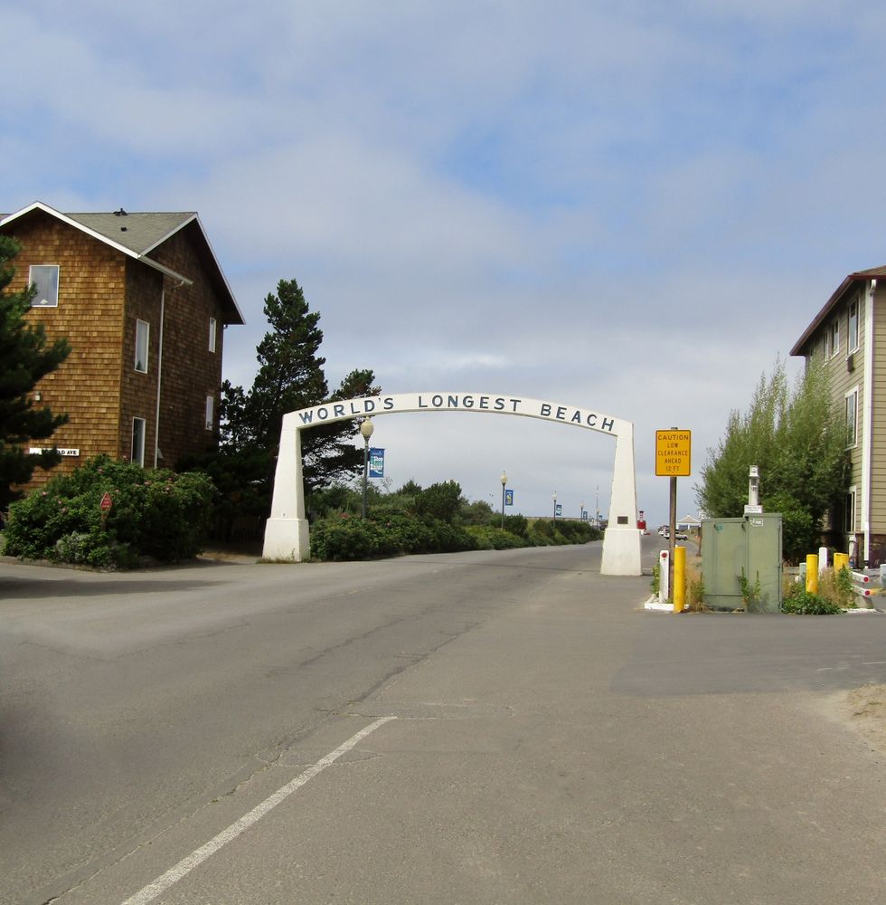 worlds longest beach sign on the archway over street in the town of long beach