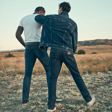 two men walking on a dirt road