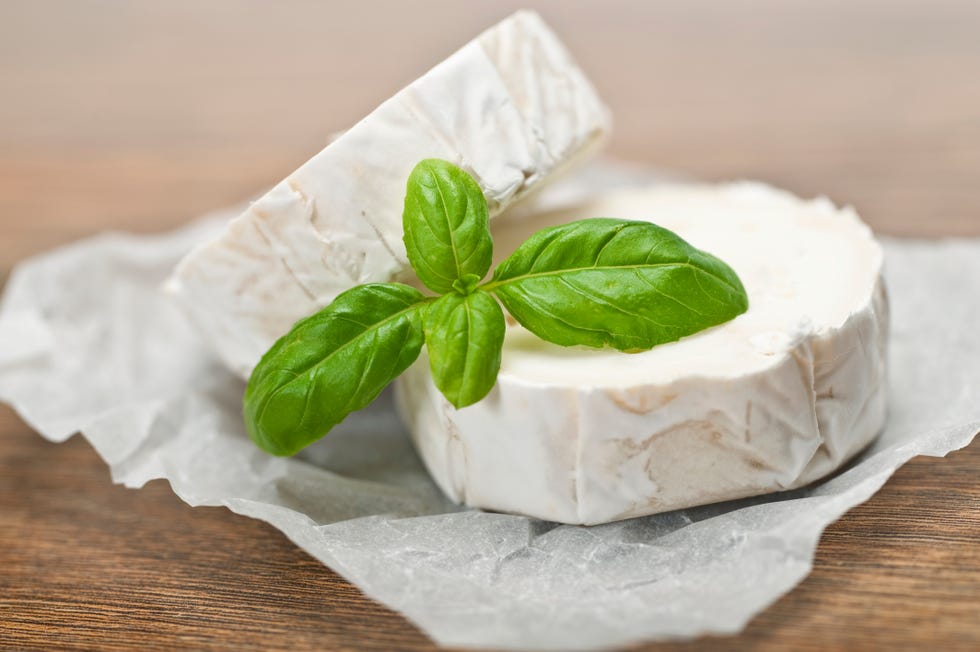 Wrapped circles or goat cheese displayed with garnish