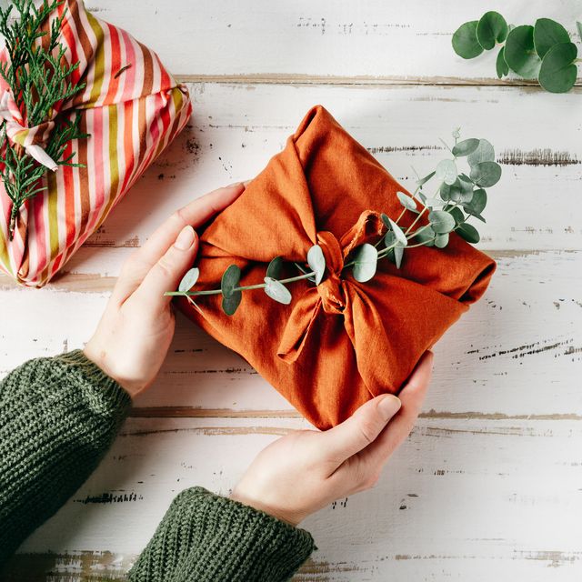 wrapping a gift in eco friendly reusable fabric package furoshiki