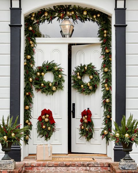 a white holiday door with christmas wreaths