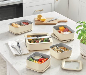 various food storage containers with diverse meals placed on a countertop