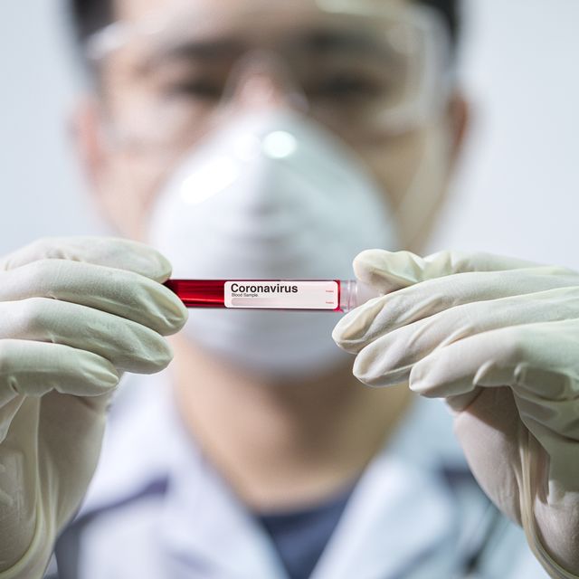 doctor holding vial of coronavirus blood sample