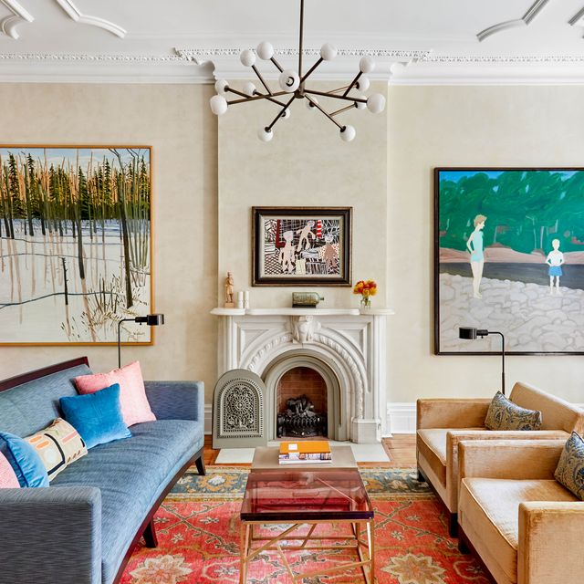 kathleen walsh living room, cream painted walls, blue couch, dusty pink chairs, artwork, statues