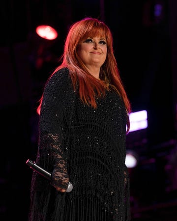 wynonna judd on stage holding microphone