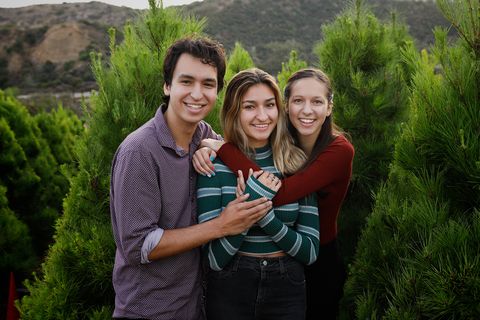 three older kids in christmas tree farm