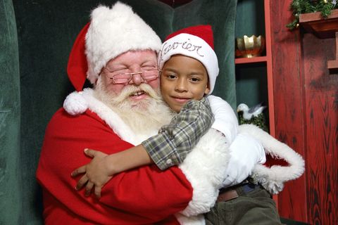 xavier gonzalez gets a big hug from santa claus at the state