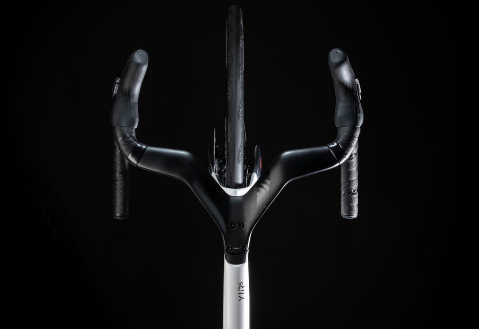 top view of a sleek bicycle frame and handlebars against a black background