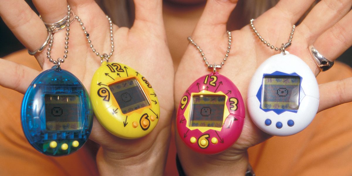 person holding four tamagotchis on hands
