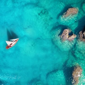 yacht on the sea from top view turquoise water background from top view summer seascape from air travel concept and idea