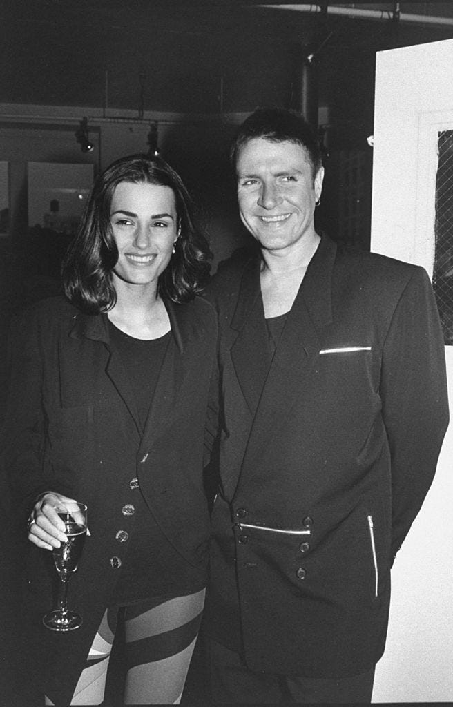 singer simon lebon standing close to his wife yasmin, who is dressed in pucci style leggings at book party photo by robin platzergetty images