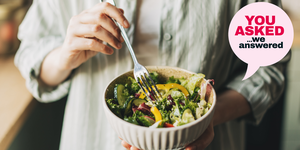 a person holding a fork and a bowl of salad