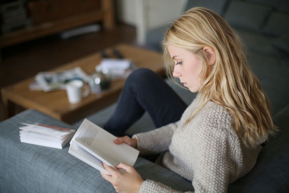 a 18 years old young woman reading a book