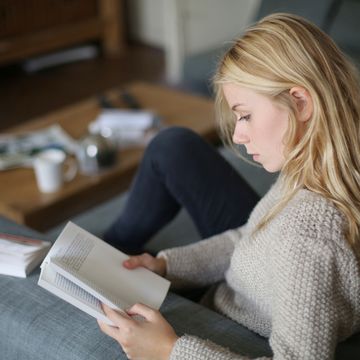 a 18 years old young woman reading a book