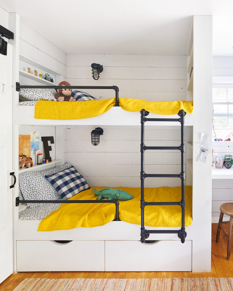 a modern farmhouse bunk bed with an industrial ladder and bright yellow bedding