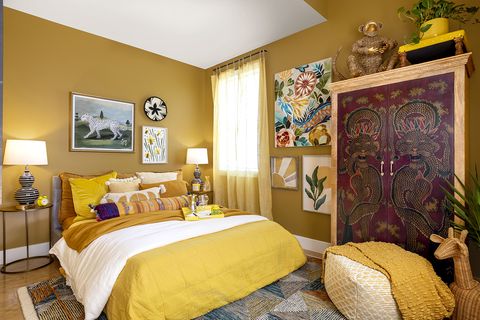 yellow bed with pillows and armoire