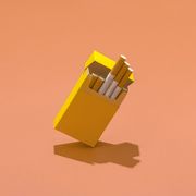 yellow cigarette pack on coral colored background