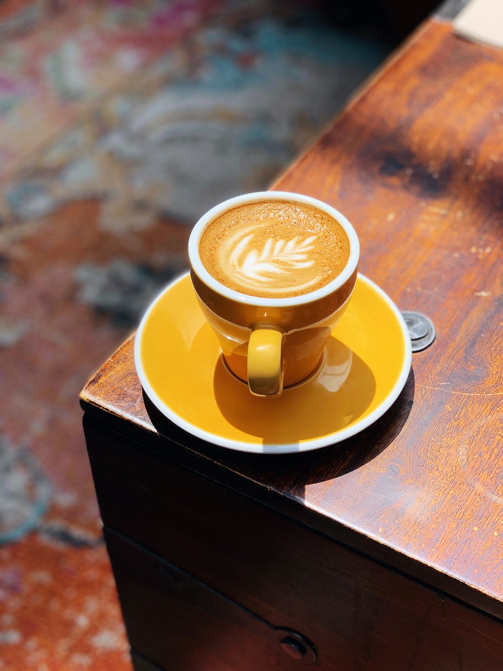 yellow coffee cup with cappuccino