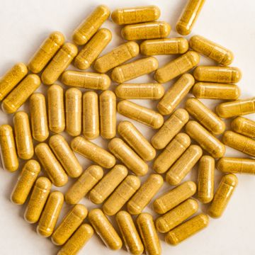 yellow color pills capsules on white background