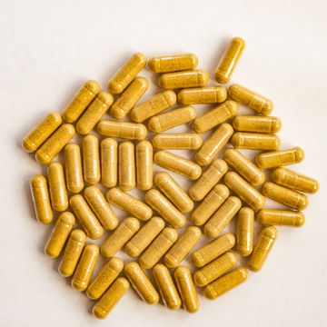 yellow color pills capsules on white background